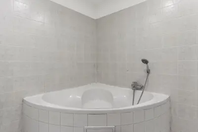a white tub in a bathroom with a shower at Royal Prague Gallery in Prague