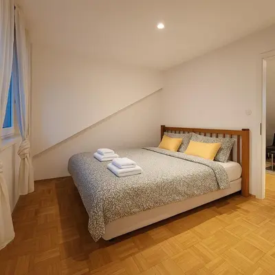 a bedroom with a bed with two towels on it at KindStay Suite w Free Parking near Prague Airport in Tuchoměřice