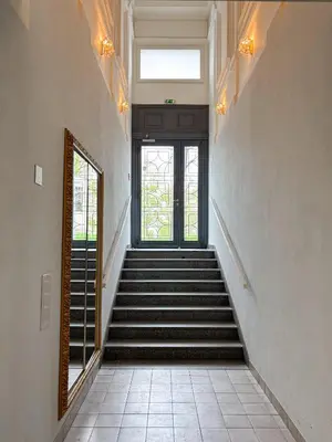 a staircase leading to a door in a building at Museum Park Apartment II in Prague