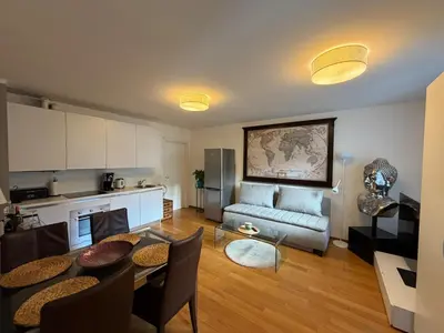 a living room with a table and a couch at Riverside Grande in Prague