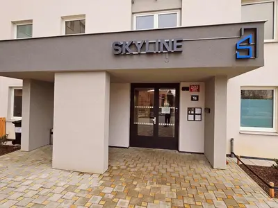 a building with a sign that reads skyline at SUPERIOR PRAGUE 2BR APARTMENT for Business & Leisure, Private Garden, Free Parking & Gym, by LIVE-INN 1 in Prague