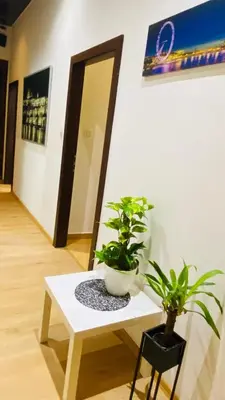 a white table with two potted plants on it at Luxus room in Prague 2 Square in Prague