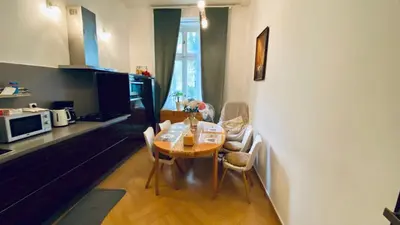 a kitchen and dining room with a table and chairs at stunning room in Prague 2 in Prague