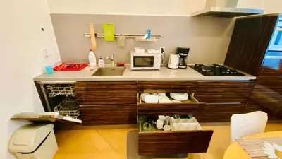 a kitchen with a sink and a microwave at stunning room in Prague 2 in Prague