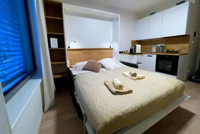 a bedroom with a bed with towels on it at Apartment Mozart in Prague