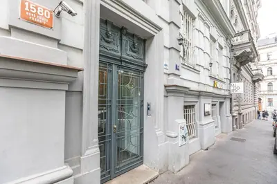 a building with green doors on the side of a street at Newly renovated apartment next to the National Museum in Prague