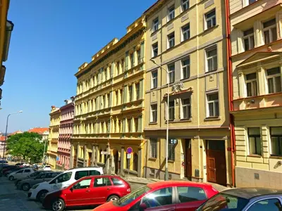 a street with cars parked in front of buildings at Apartment Paradies-Wohnung by Interhome in Prague