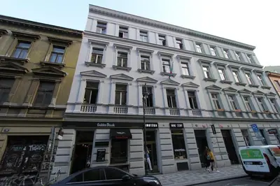 a large white building on a city street at Central cozy rooms Soukenická S32 in Prague