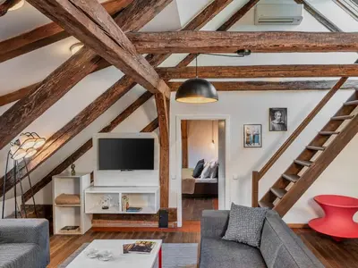 a living room with wooden ceilings and wooden beams at Three Bedroom Apartment with terrace Kepler-4 Art in Prague