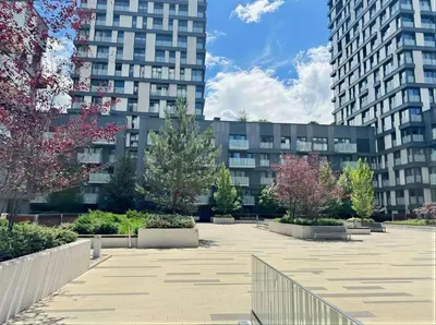 a courtyard in front of a building with tall buildings at Fortuna Garden II in Prague