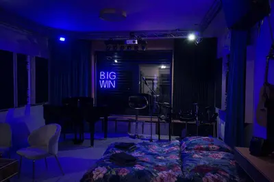 a bedroom with a bed and a big win sign at Studio Big Win Mělník in Pšovka
