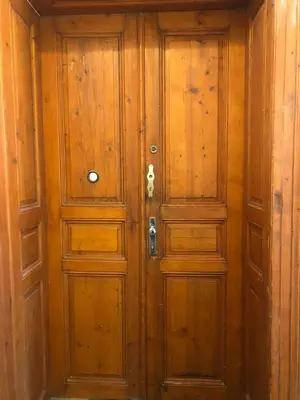 a pair of wooden doors in a room at Central cozy rooms Soukenická S33 in Prague