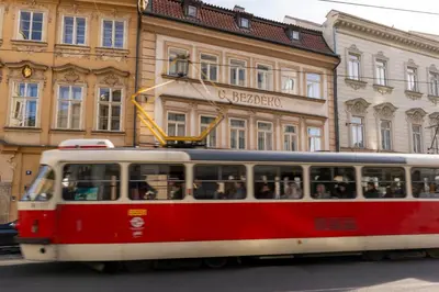 a red and white tram in front of a building at Apartment in Prague 1 next to Wenceslas Square in Prague