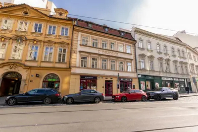 a group of cars parked in front of a building at Cozy Central apartment by Charles Square in Prague