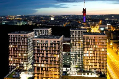 a view of a city at night with a television tower at Fortuna Garden III in Prague