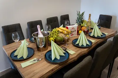 a wooden table with plates of fruit and wine glasses at Golden Aurora Prague in Prague