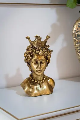 a gold bust of a woman wearing a crown at Lion Prestige Residence in Prague