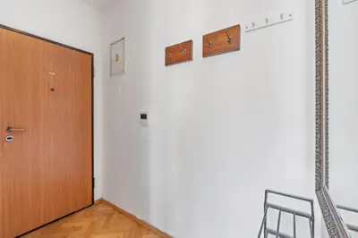 a room with a wooden door and a chair at Grand Gallery Riverside in Prague