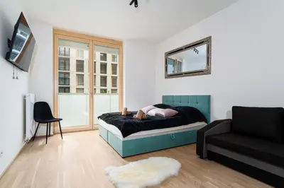 a person laying on a bed in a living room at Big Central Living in Prague