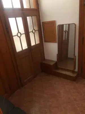 a bathroom with a mirror and a wooden door at Central cozy rooms Soukenická S34 in Prague