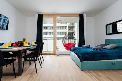 a bedroom with a bed and a table and a dining room at New Bohemian Apartment in Prague