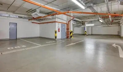 an empty parking garage with yellow and white markings on the floor at Centre Design Suite O2 Arena - Parking-Balcony-big TV-Coffee, 24 7 Self Check-in in Prague
