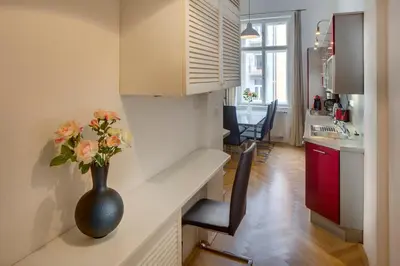 a vase with flowers sitting on a counter in a kitchen at Old Town Square Apartments in Prague