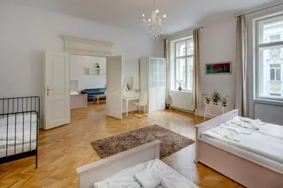 a large bedroom with a bed and a room with a mirror at Old Town Square Apartments in Prague