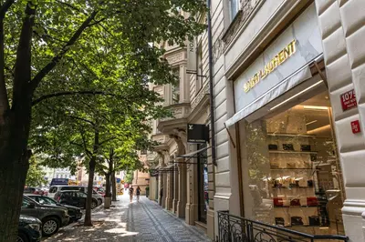 a street with a store on the side of a building at Wishlist Prague Residences - Old Town Bilkova in Prague