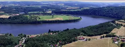 an aerial view of a lake with a golf course at Chaloupka za potůčkem in Županovice