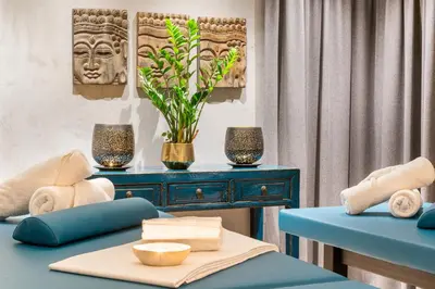 a living room with a blue couch and a table at MOSAIC HOUSE Design Hotel in Prague