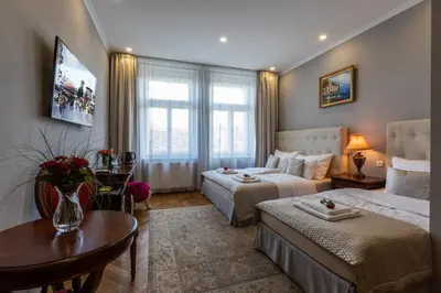 a hotel room with two beds and a table at SlaBur Residence in Prague