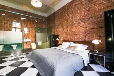 a bedroom with a bed and a checkered floor at Old Town - Dusni Apartments in Prague