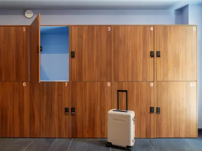 a suitcase sits in front of a row of lockers at Numa Prague Root in Prague