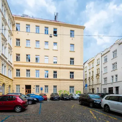 a large building with cars parked in front of it at Modern apartment few steps from centre in Prague