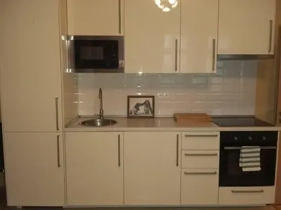 a kitchen with white cabinets and a sink at NOT POSSIBLE TO BOOK Apartment Vltavska F in Prague