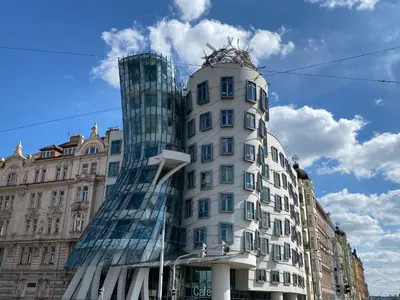 a tall white building with a glass facade at Holiday Home Sunset Terrace by Interhome in Prague