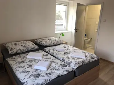 a bed with two pillows on it in a room at Motel Red Oil in Lovosice