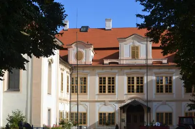 a building with a clock tower on top of it at Tradiční český dům s ložnicemi v podkroví in Všejany