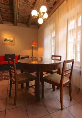 a dining room with a table and chairs and a couch at Mala Strana apartment 1 in Prague