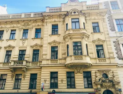 a yellow building with a lot of windows at Arch III at Wenceslas in Prague