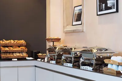 a buffet with many plates of food on a table at Hotel Hoffmeister in Prague