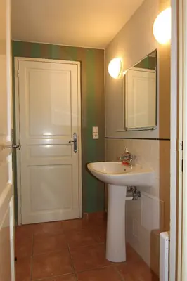 a bathroom with a sink and a mirror and a door at 1 Bed Flat - Sleeps 3 - Pets - Wifi in Prague