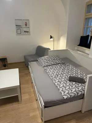a bedroom with a bed and a couch at Nerudova Apartments in Prague