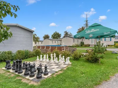 a chess board on a lawn with an umbrella at Holiday Home Prima by Interhome in Prague