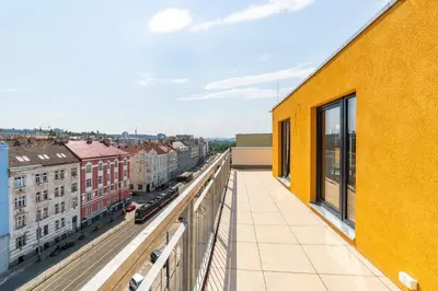a balcony with a view of a city at One bedroom penthouse apartment # 82 in the brand new building close to the city center with free parking in Prague