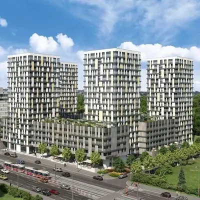 two tall white buildings in a city with a street at Residence Garden Tower - 8 min do centra, garaz in Prague