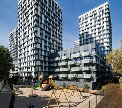 a playground in front of a building with two tall buildings at Residence Garden Tower - 8 min do centra, garaz in Prague