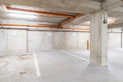 an empty parking lot in an empty parking garage at Brand new two room apartment #26 with free secure parking close to center in Prague