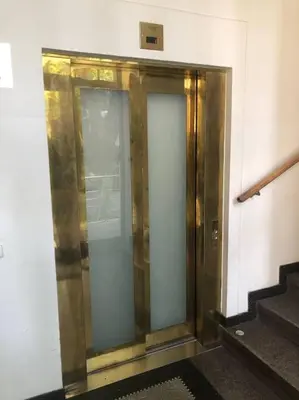a elevator in a building with glass doors and stairs at Exclusive Unique Apartment - Prague Central in Prague